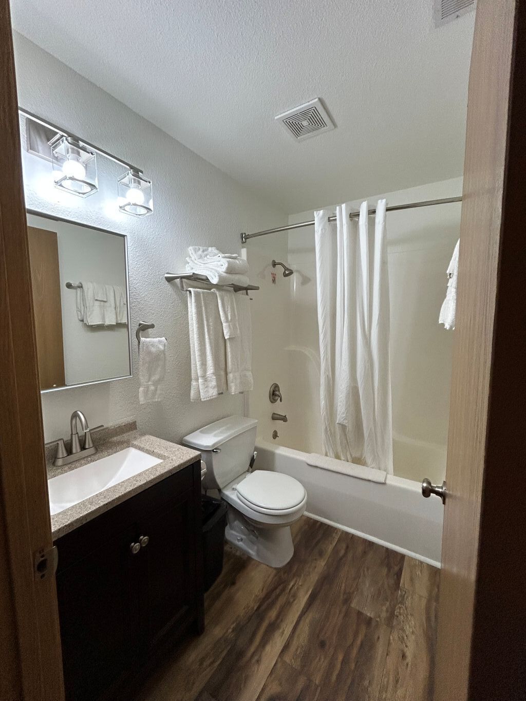 Un baño con lavamanos, inodoro y bañera.