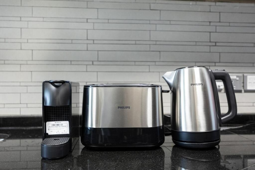 A kitchen with a coffee maker, a toaster, and a kettle, all branded by Philips.