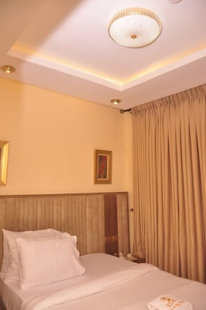 Family Room | Desk, laptop workspace, blackout curtains, soundproofing - Eden Luxury Suites (Lagos)
