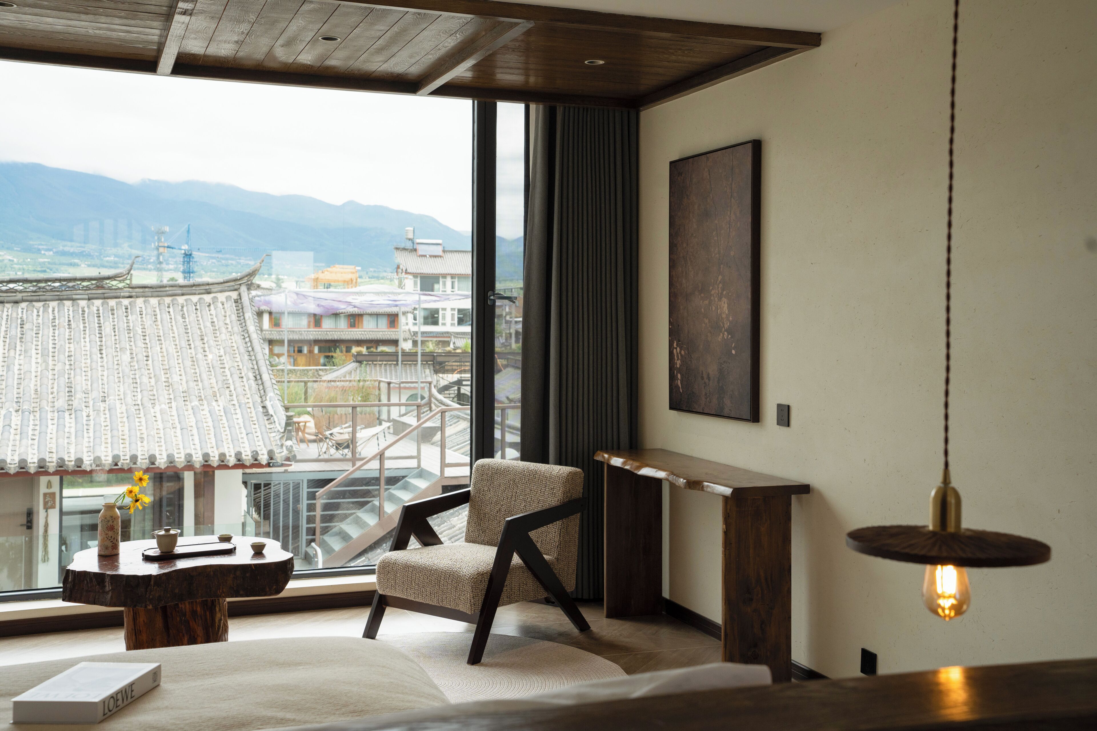 A modern interior with a view of traditional buildings and mountains.