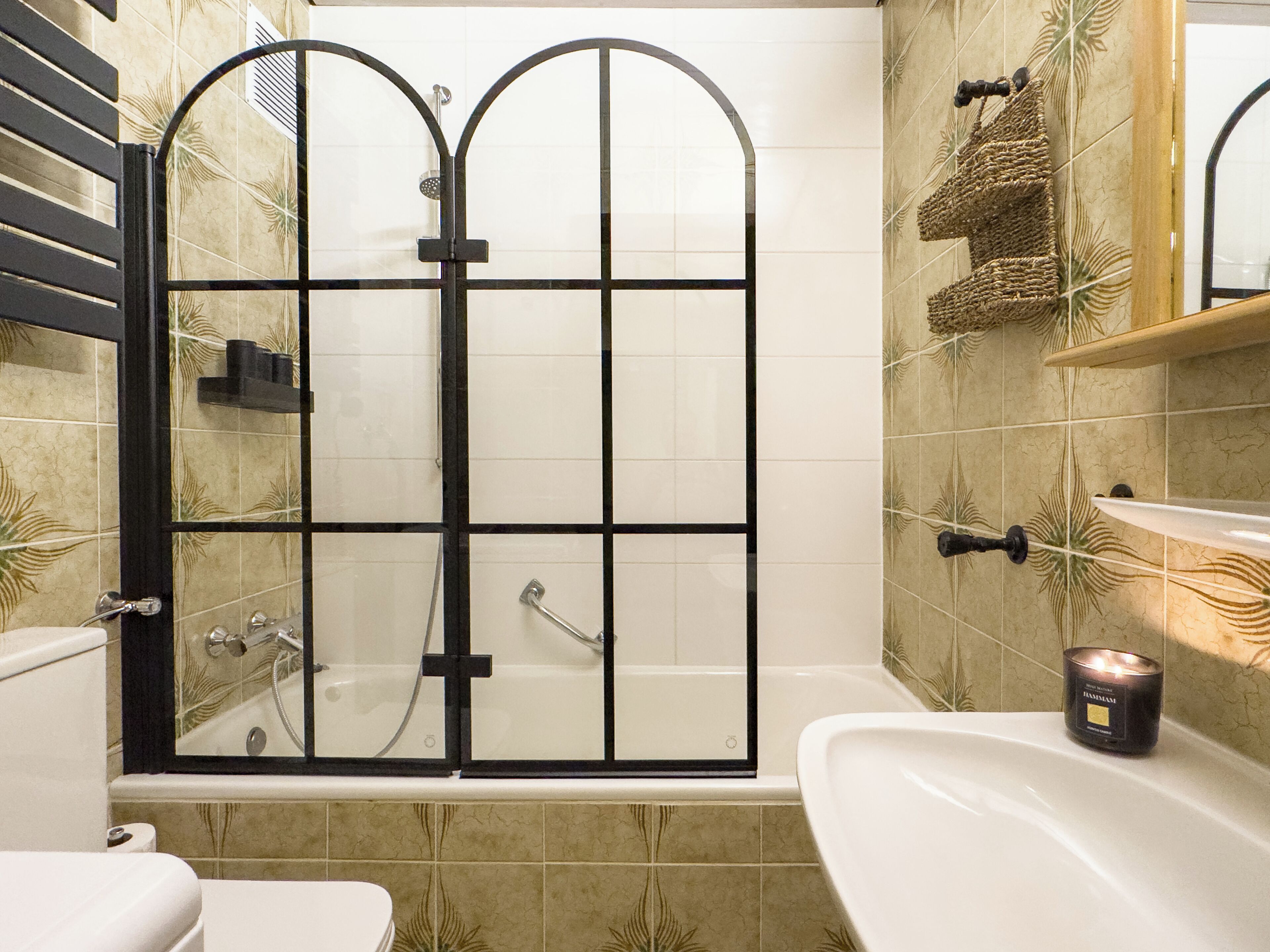A bathroom with a shower enclosure, a bathtub, and a sink.