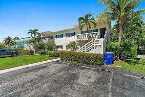 A modern hotel with a two-story structure, a covered outdoor area, and a parking lot. - 2BR 1BA Renovated Beach Apt in a Small Building (West Palm Beach)