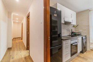 A modern kitchen with a refrigerator, oven, and sink. - Explore Zaragoza from the City Center (Zaragoza)