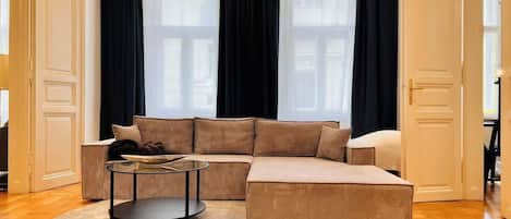 A modern living room with a sectional sofa, a round coffee table, and a fluffy rug.