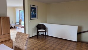 A room with a patterned floor, a framed artwork on the wall, and a chair. - Mühlenberg Vacation Home (Grebin)