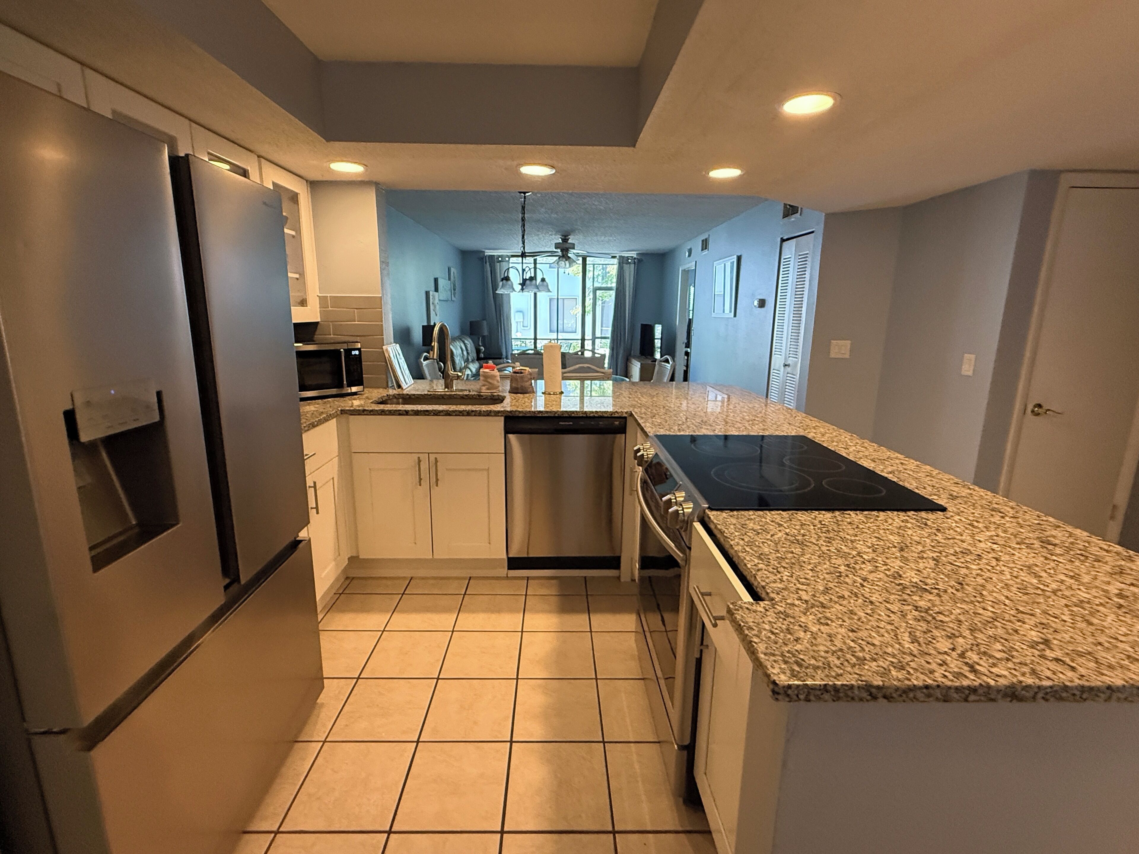 A modern kitchen with a built-in oven, microwave, and dishwasher.