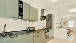 Een moderne keuken met een ingebouwde oven, een kookplaat en een spoelbak.