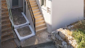 A multi-level building with a staircase, balconies, and a tiled roof. - The Yellow Donkey, Koumeika Traditional Gem Samos (Koumeika)