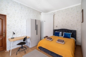 A bedroom with a bed, a desk, a chair, a wardrobe, and a door. - Heart of Old Town TOP location 1-Bedroom Apartment (Riga)
