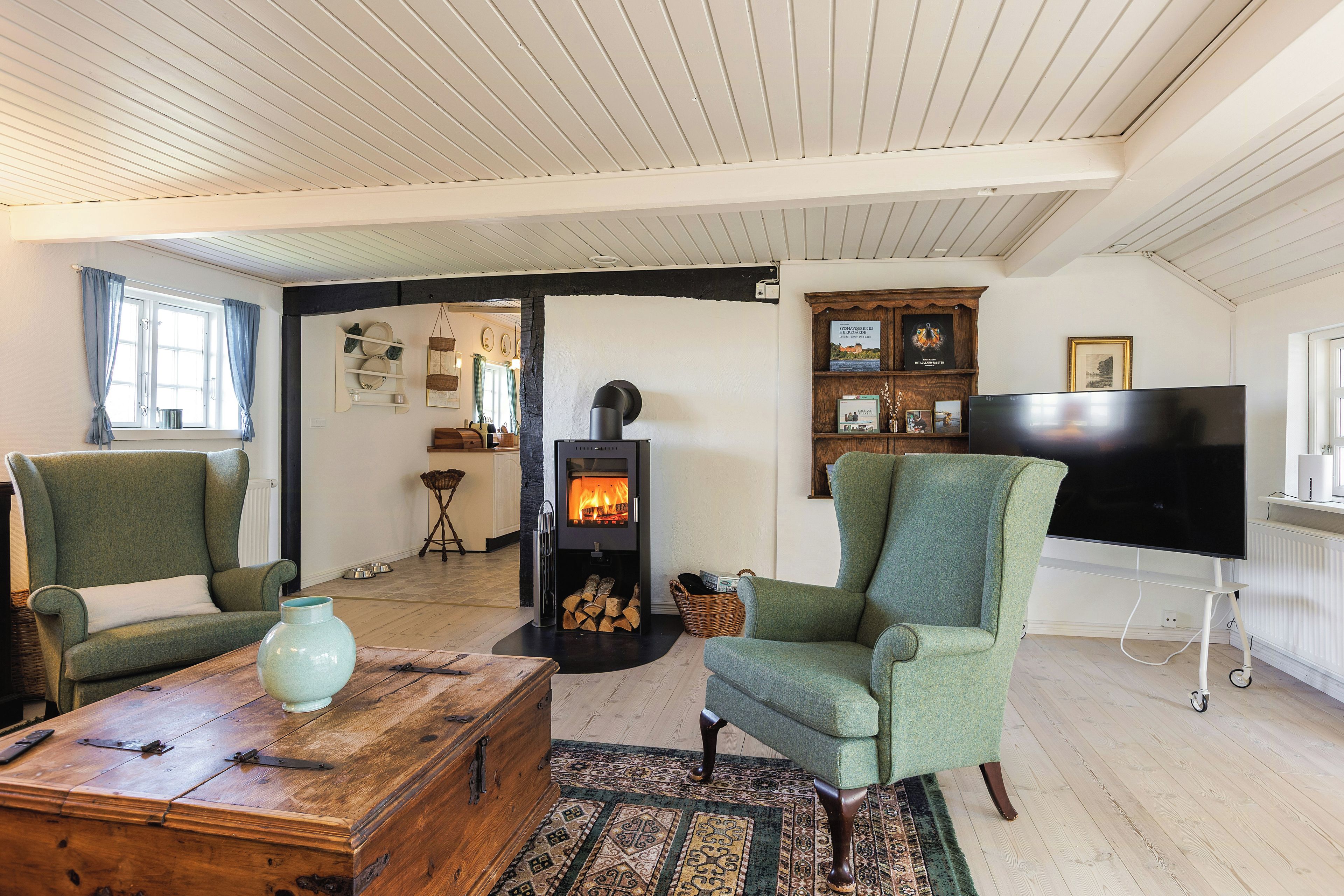 A cozy living room with a fireplace, a television, and comfortable seating.