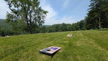 A grassy field with two American flag-themed games.