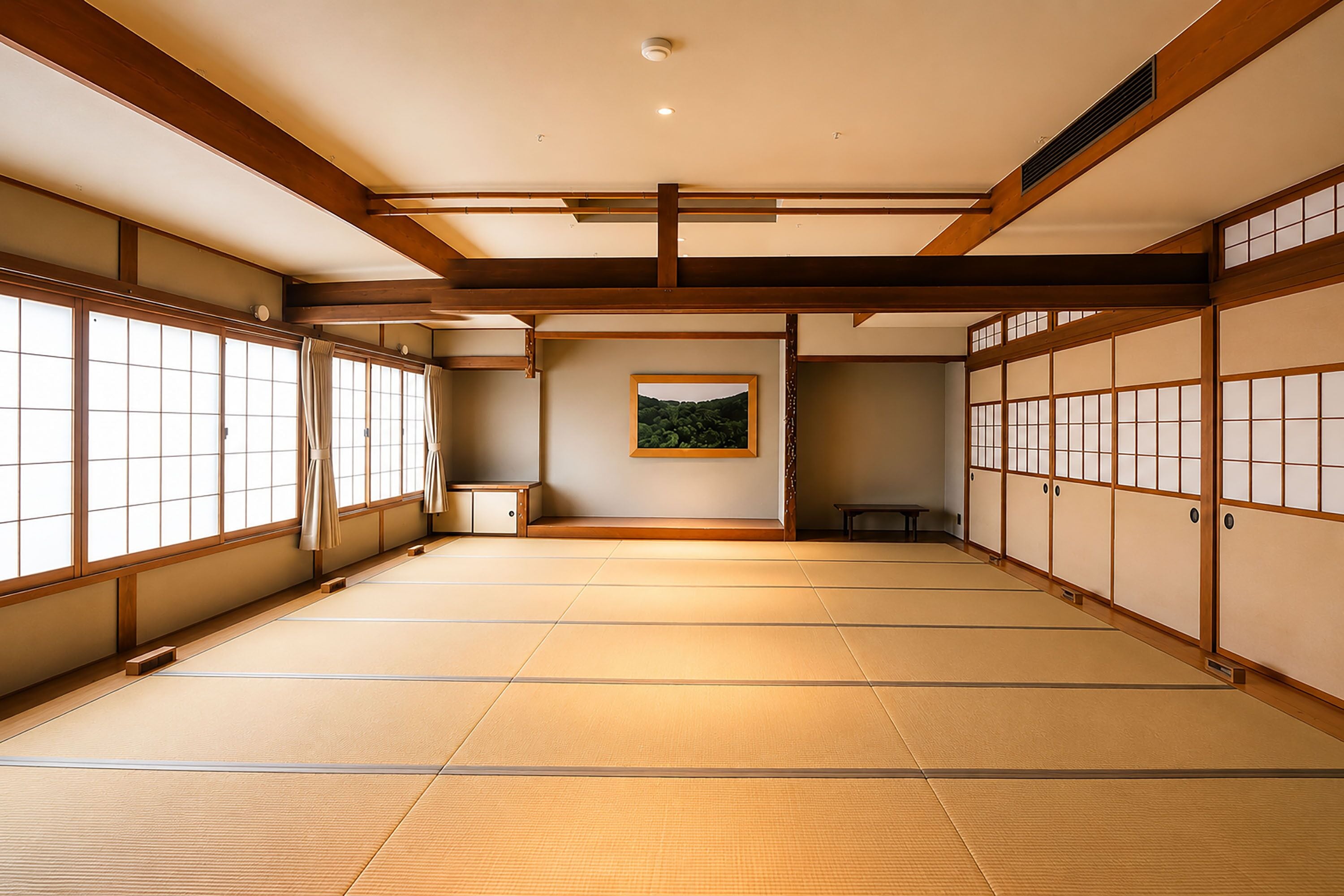 A traditional Japanese room with tatami flooring, sliding doors, and a framed picture on the wall.
