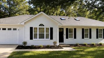 A single-story house with a garage, a front porch, and a small front yard.