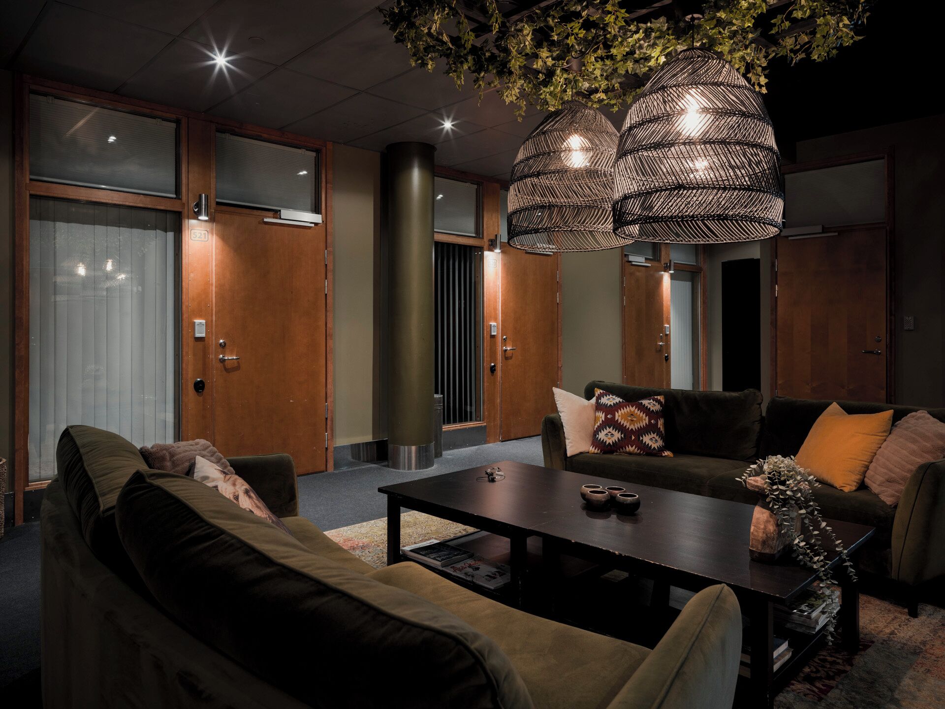 A modern living room with a sofa set, a coffee table, and a decorative plant.
