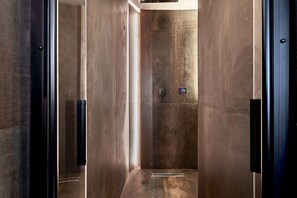 A modern elevator with metallic walls and a control panel. - Luxury Loft in Campo de' Fiori (Roma)