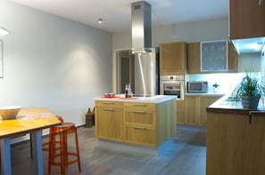 A modern kitchen with wooden cabinets, stainless steel appliances, and a central island. - Villa Santolina - Three Bedroom Villa, Sleeps 6 (Lefkada City)