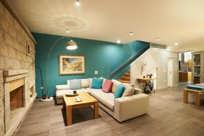 A modern living room with a sofa, coffee table, and a painting on the wall. - Villa Santolina - Three Bedroom Villa, Sleeps 6 (Lefkada City)
