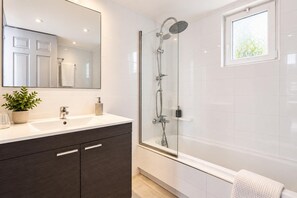 A modern bathroom with a glass-enclosed shower, a large mirror, and a white vanity with dark cabinets. - Villa Thalia Galini - Two Bedroom Villa, Sleeps 4 (Vassilikos)