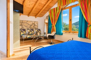 Traditional twin bedroom with blue bedding, exposed wooden beams, colourful curtains, and rustic Mediterranean decor. - Villa Tireda Tria - Three Bedroom Villa, Sleeps 6 (Koridallos)