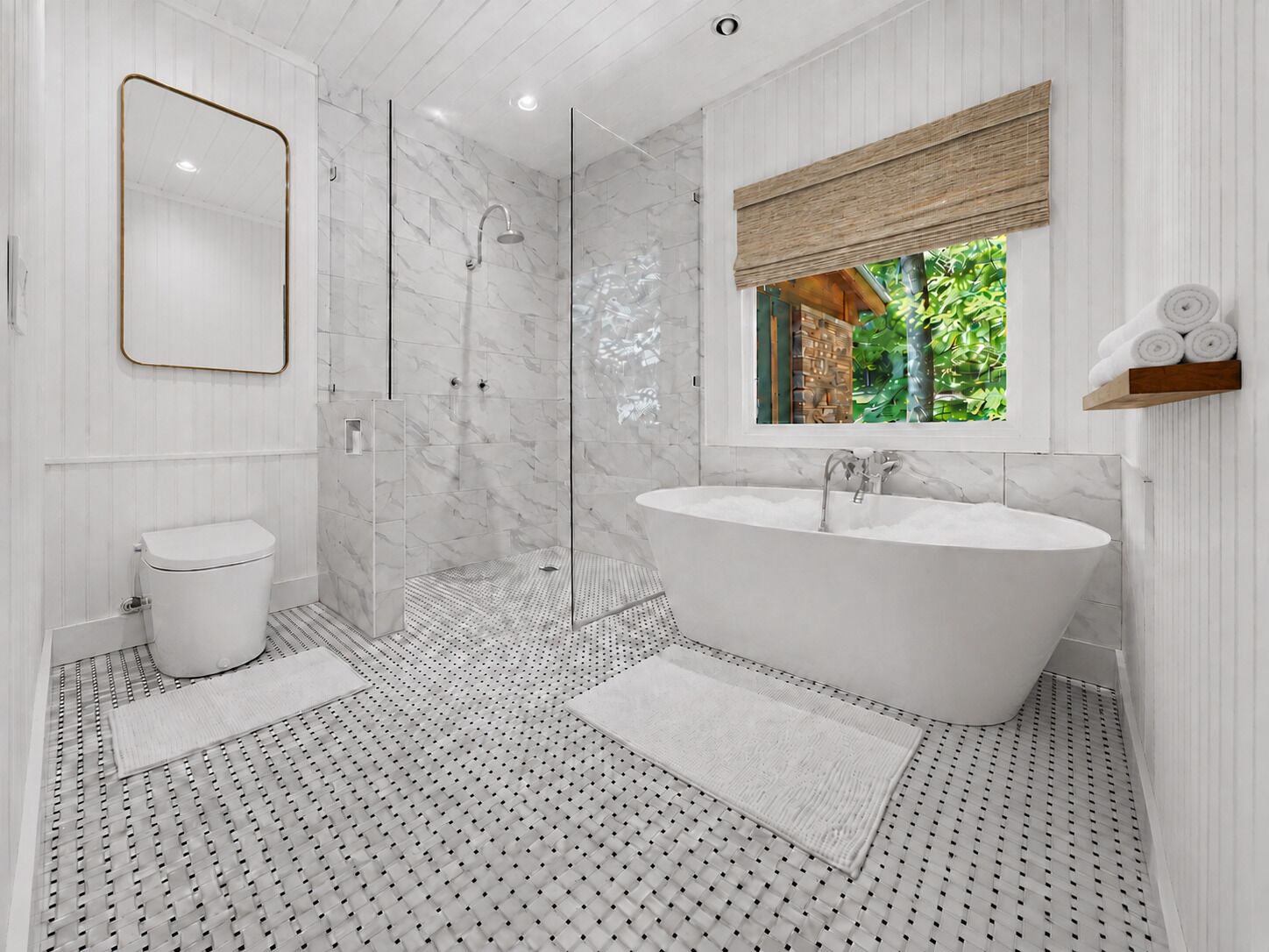 A modern bathroom with a freestanding bathtub, a walk-in shower, and a toilet.