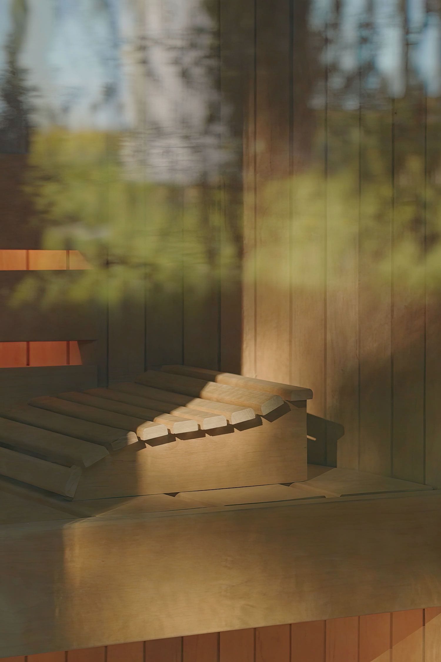 A wooden staircase leading to a higher level, with a view of trees and sky in the background.
