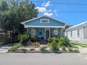 A two-story house with a porch, a star decoration, and a mailbox. - Historic 1908 Ybor City Bungalow (Tampa)