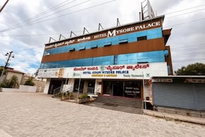 A multi-story hotel with signage in multiple languages, including English and Tamil. - Fabhotel Udupi (Mysore)