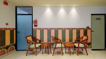 A reception area with a hand wash station, a blue door, and a patterned wall.