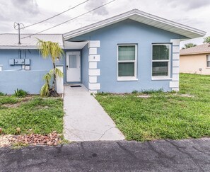 A single-story house with a front door, a small porch, and a grassy yard. - Lakeside Oasis Fort Myers (Fort Myers)