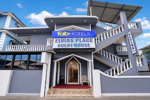 A building with a sign reading 'Fab Hotels Elvis Place Guest House'.