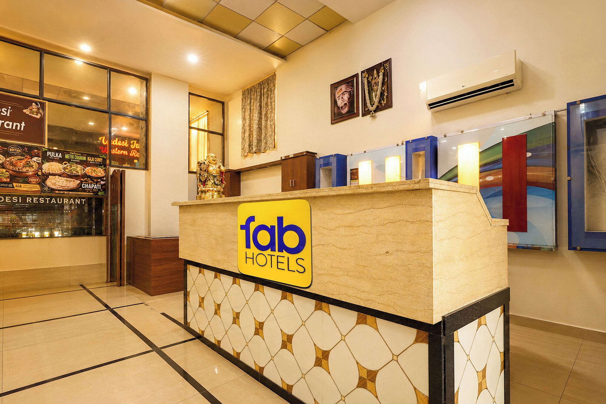 A hotel reception desk with a sign for 'fab hotels'.