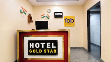 A reception desk with a sign that reads 'HOTEL GOLD STAR'.