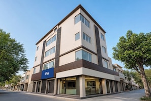 A multi-story building with a prominent 'Vía' sign, large windows, and a modern architectural design.
