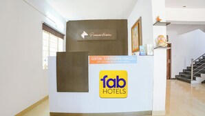 A reception desk with a sign for Peninsula Holidays and a logo for Fab Hotels.