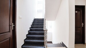 A staircase with a handrail, leading to a landing with a door marked '106'.