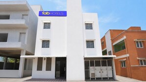 A modern building with a prominent sign for 'fabHOTELS' above the entrance.