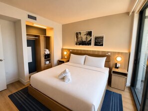 A hotel room with a bed, a wardrobe, a nightstand, and a window. - Gorgeous 1 Bedroom with balcony and amazing views (Miami)