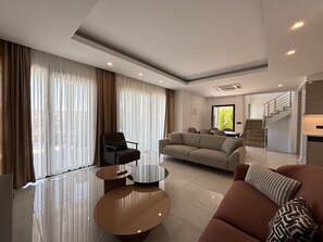 A modern living room with a sofa, armchairs, and a coffee table. - Elegant Türkbükü Retreat | Private Pool (Bodrum)