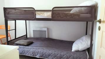 A bunk bed with a headboard, a pillow, and a mattress.