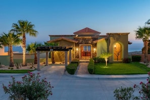 A residential property with a well-maintained lawn, a covered patio, and a stone facade. - Pueblo Bonito Montecristo Luxury Villas - All Inclusive (Cabo San Lucas)