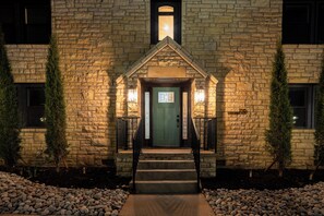 A stone building with a green door, a small porch, and a stone staircase leading to the entrance. - Luxury Apartment B on TU Campus 2 Mins to downtown (Tulsa)