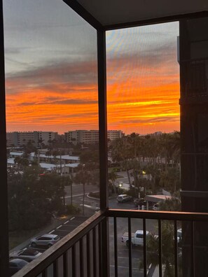 A sunset view from a balcony with a cityscape in the background. - Resort amenities in siesta Key! (Siesta Key)