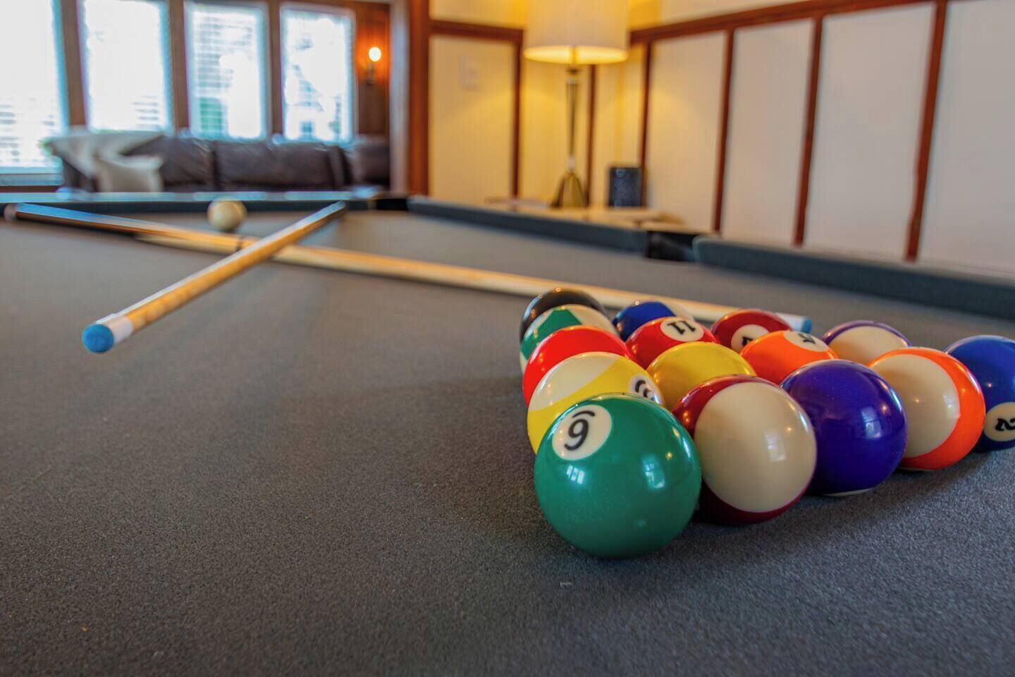 Une table de billard avec des billes et une queue de billard.
