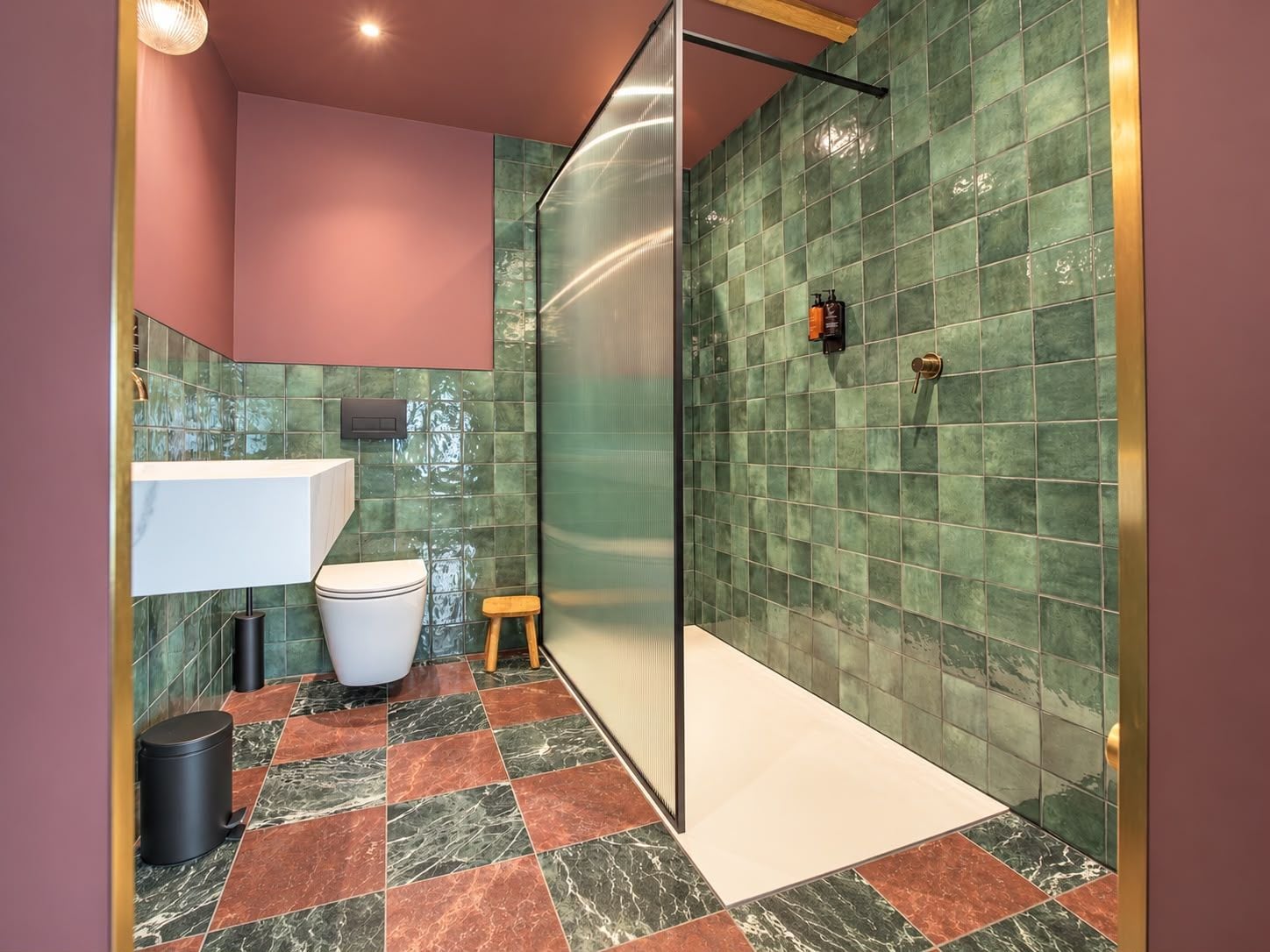 A bathroom with a white sink, a toilet, and a shower area.