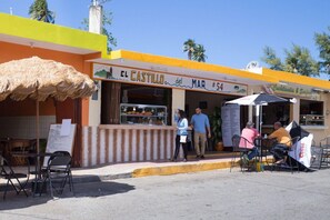 Ein Restaurant namens 'El Castillo del Mar' mit Außenbereich und einer sichtbaren Speisekarte.