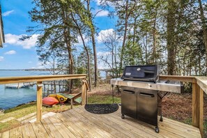A deck with a grill and a view of the water. - ★ LAKE NORMAN WATERFRONT COTTAGE, PETS ALLOWED ❤ DOCK + KAYAKS w/FIRE PIT (Lake Norman of Catawba)