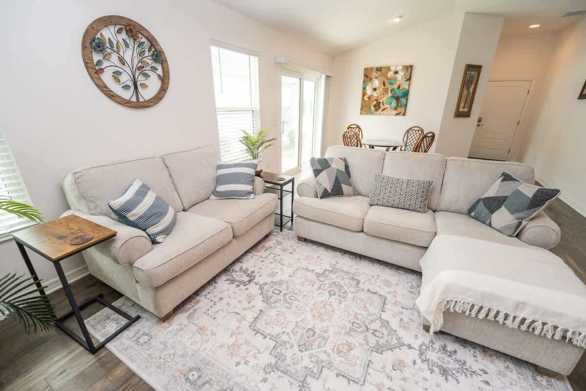 A living room with two sofas, a coffee table, and a rug.