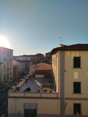 A street view with buildings, a clear sky, and a sign indicating a professional restoration service. - Very bright apartment, a 15-minute walk from the historic center - AC - Wi-Fi (Firenze)