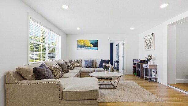 A living room with a sofa, coffee table, and artwork on the walls. - Family Oasis • Playset • Near Airport & Stadium (Tampa)