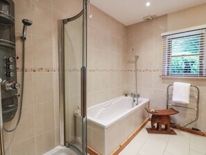 A bathroom with a glass-enclosed shower, a bathtub, and a window with blinds. - Deers Leap (Dalbeattie)